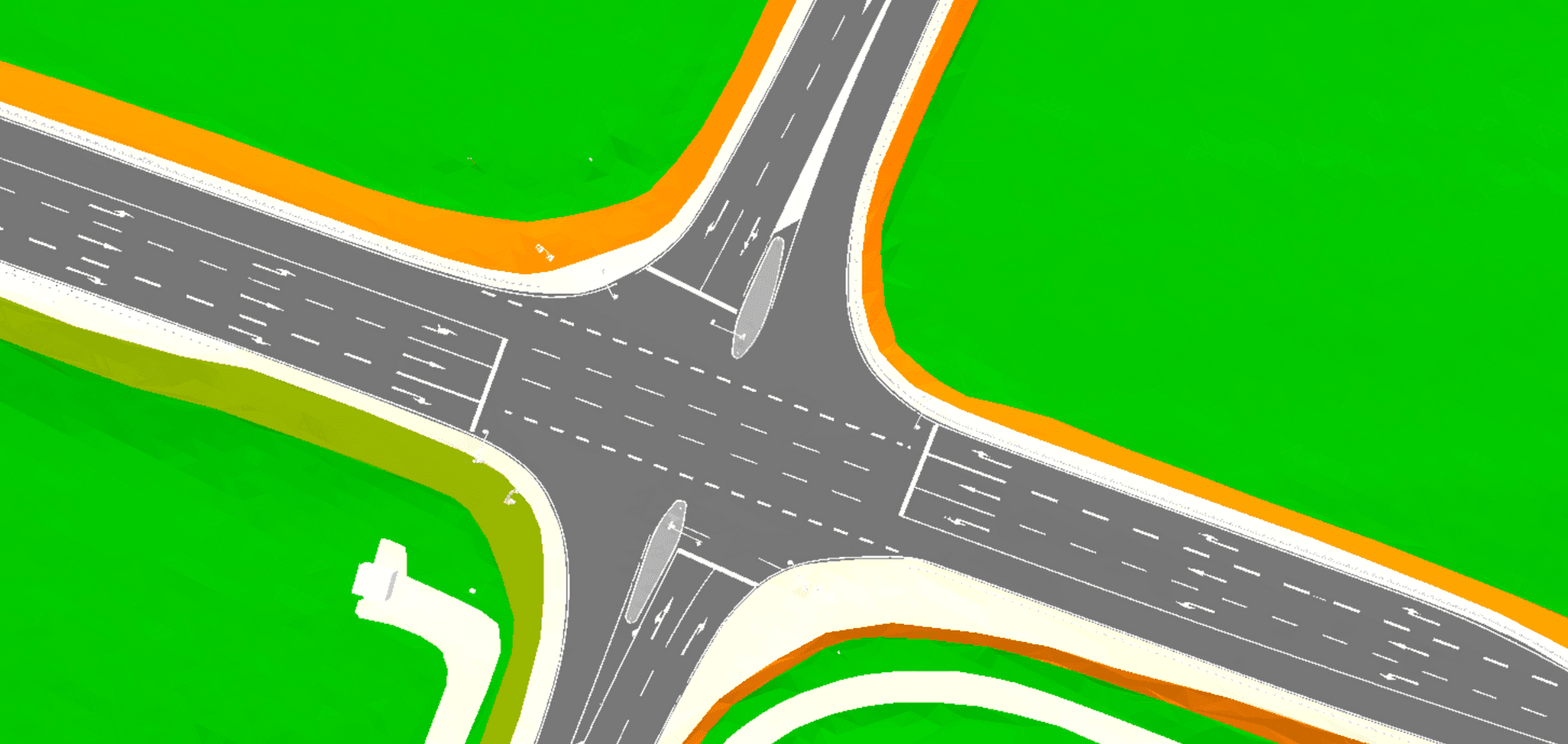 Aerial view of a multi-lane intersection with road markings and green surrounding areas.