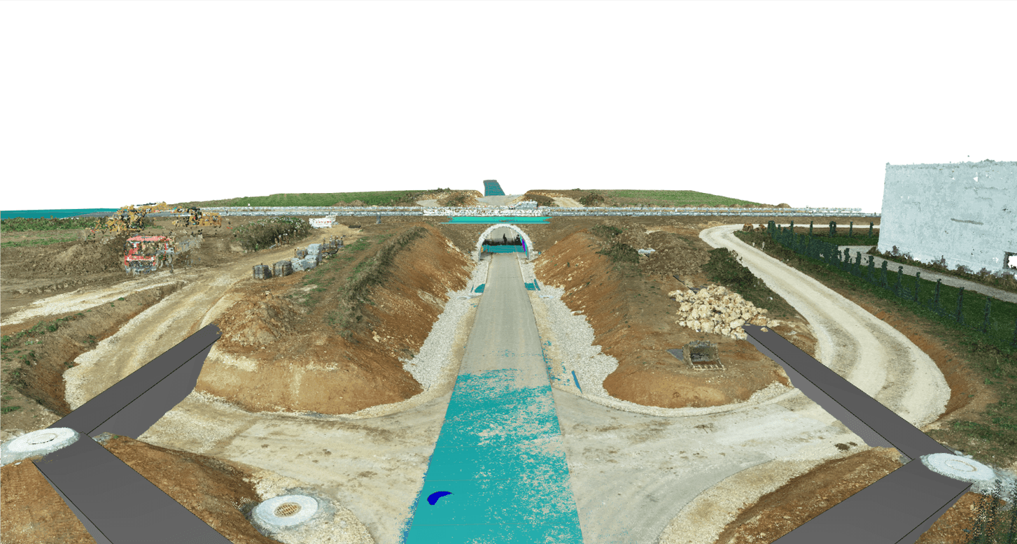 Construction site showing a tunnel entrance in progress, surrounded by dirt roads and construction vehicles.