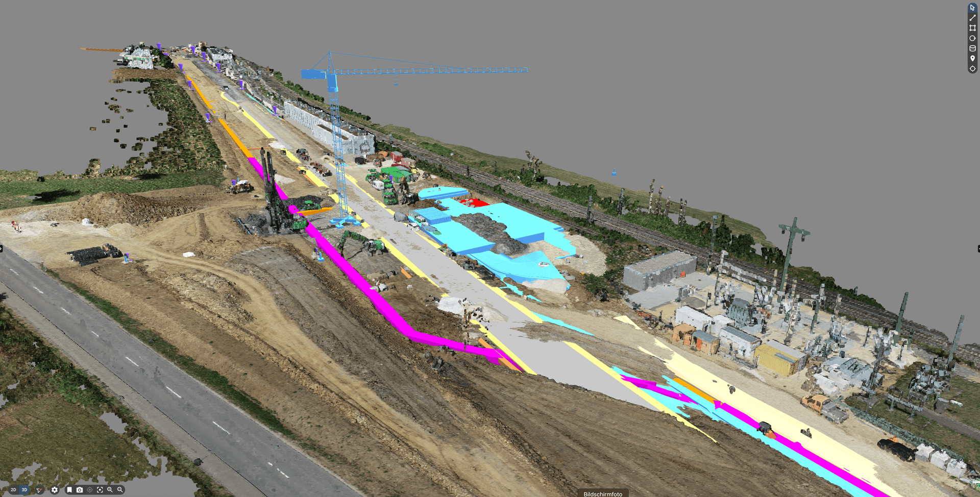 Aerial view of a construction site with various colored areas, machinery, and structures under development.