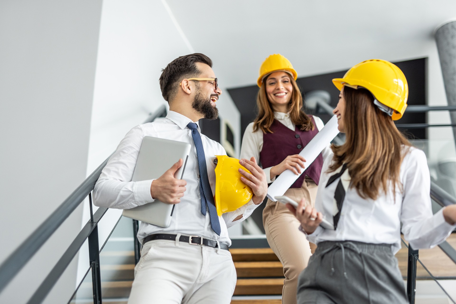 Architects and engineers discussing on stairs in office building